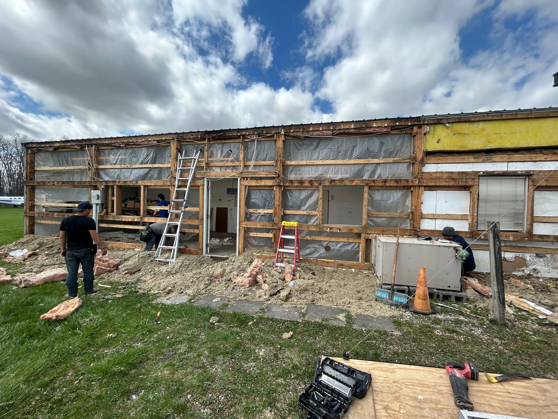 Full exterior wall remodel with metal siding insulation and awning image