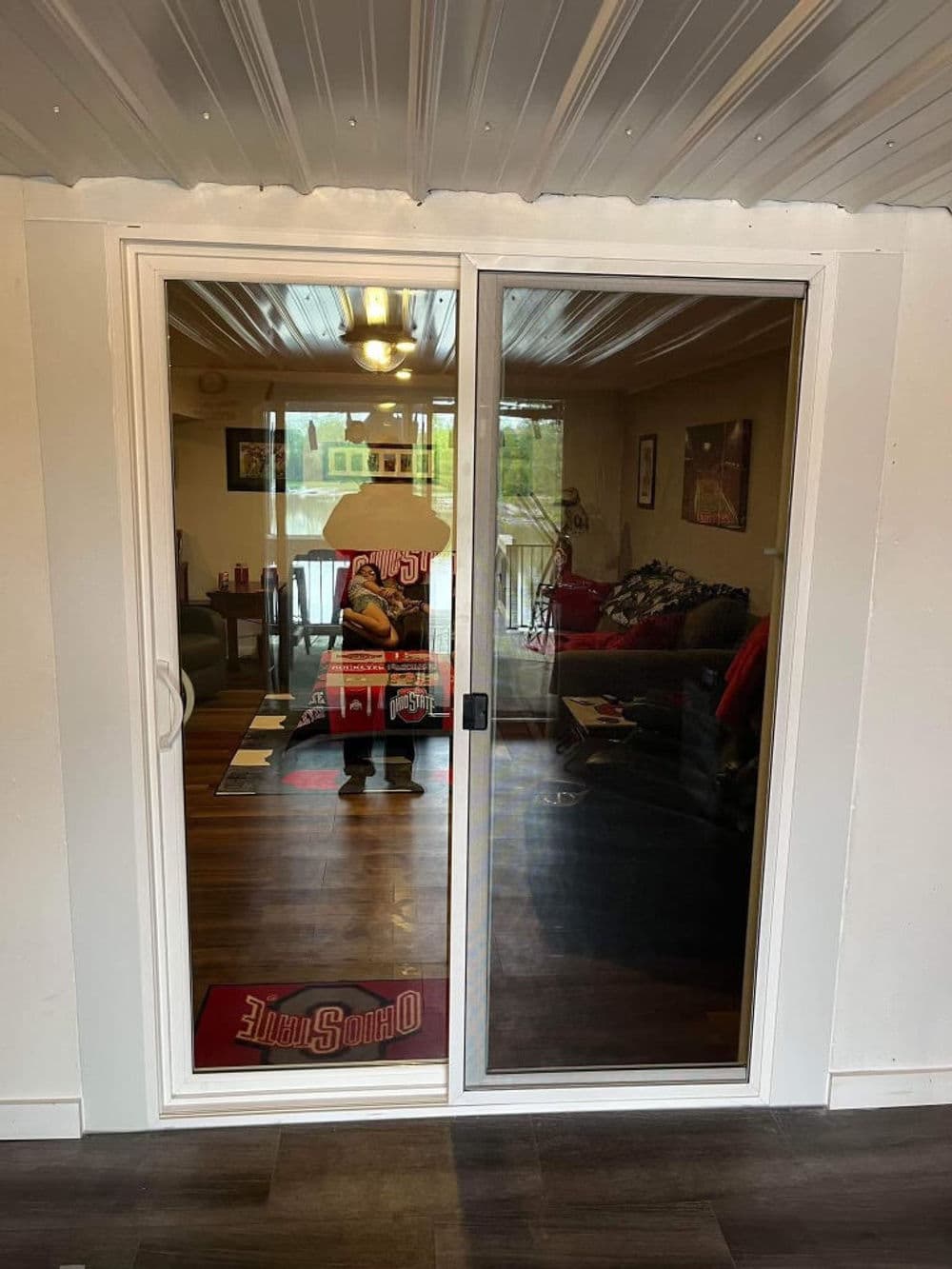 Sliding glass patio door leading to a cozy living room with modern decor and natural light.